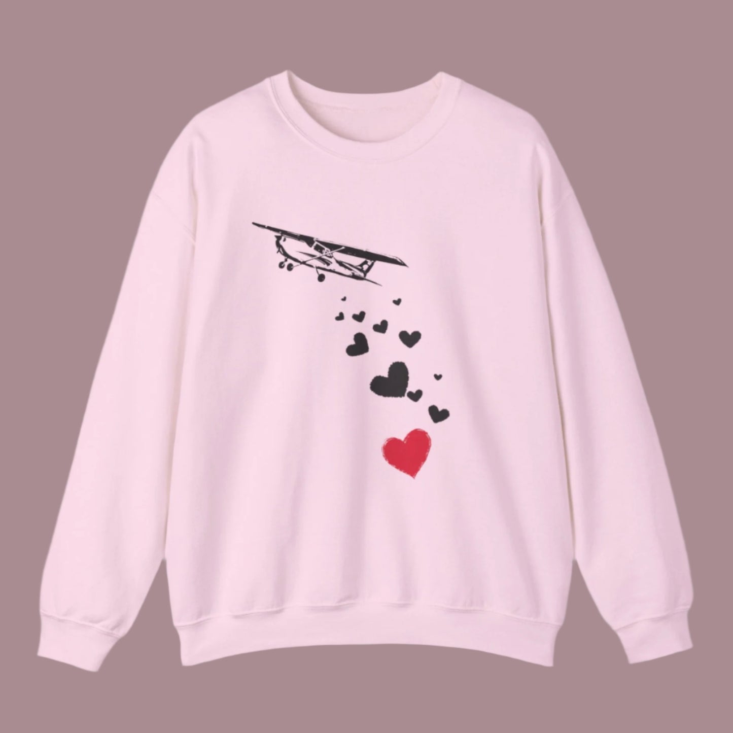 Sweatshirt of airplane dropping hearts