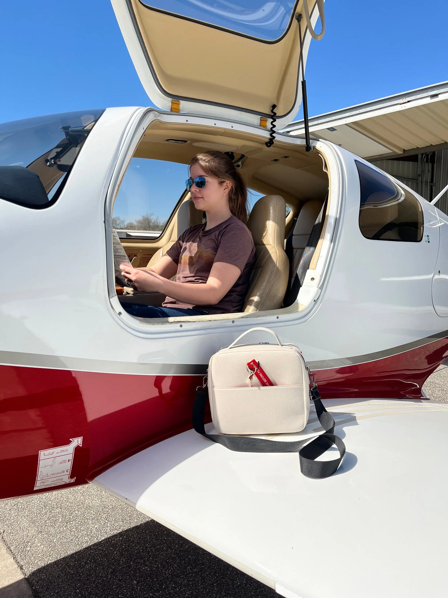 Ladies Flight Bag on wing of airplane