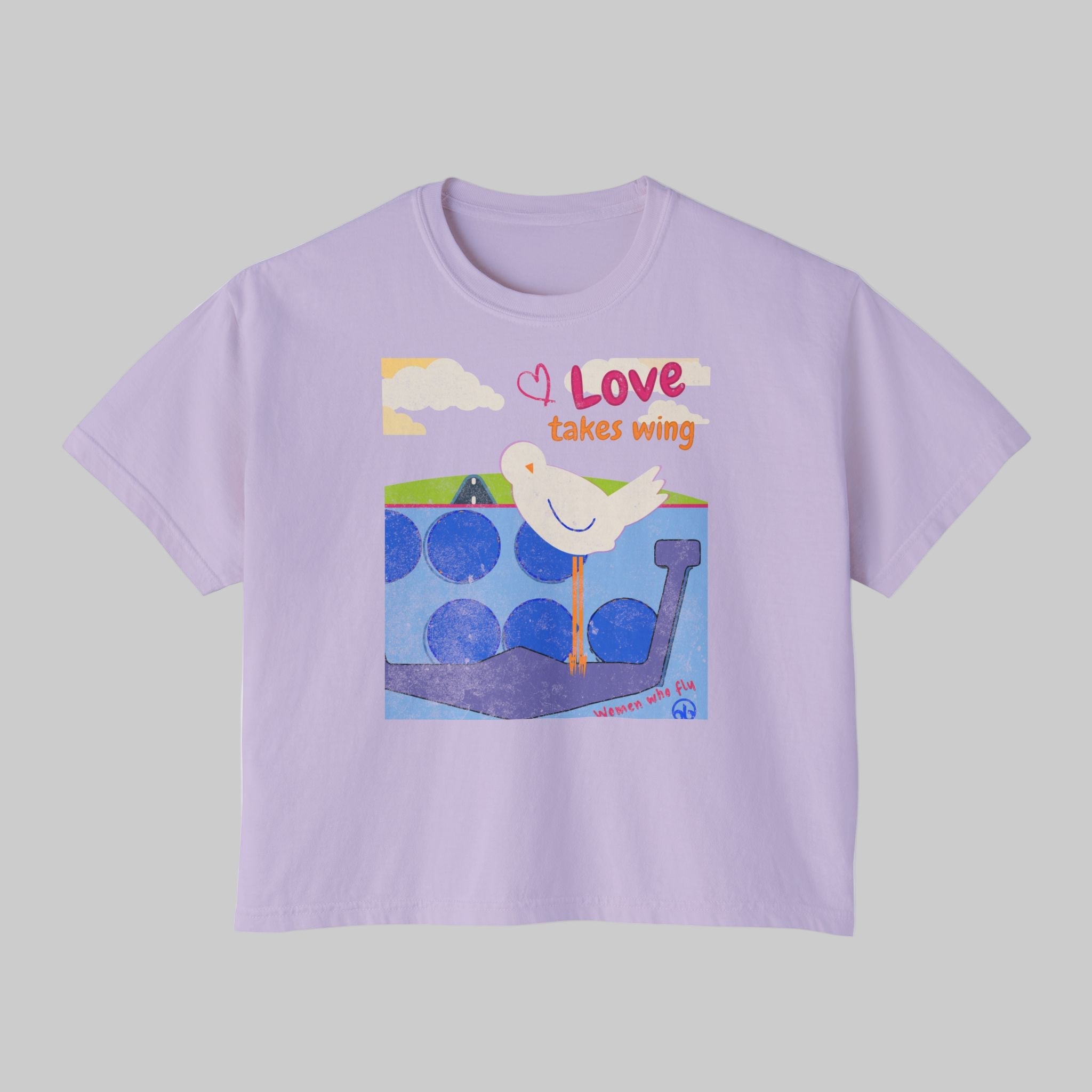 Lavender t-shirt with a graphic of a dove and text 'Love takes wing' on a white background