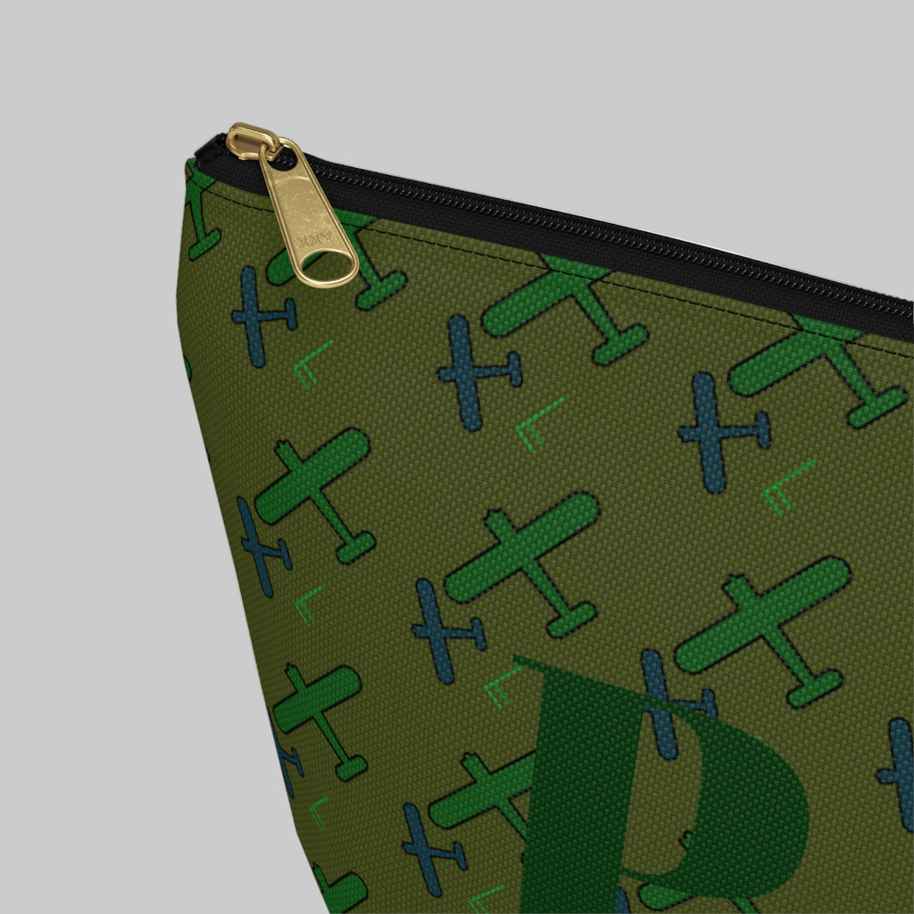 Green pouch with airplane pattern and gold zipper on a white background