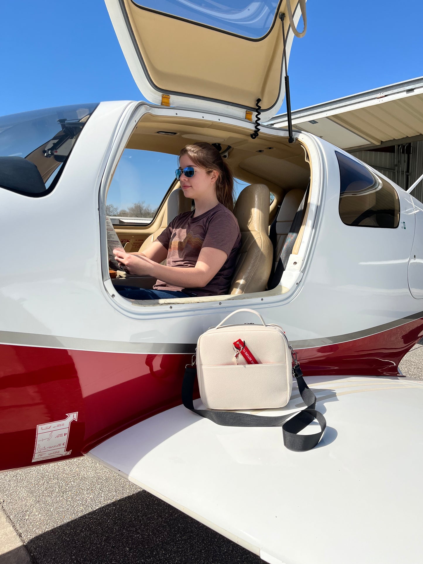 Ladies Flight Bag on wing of airplane