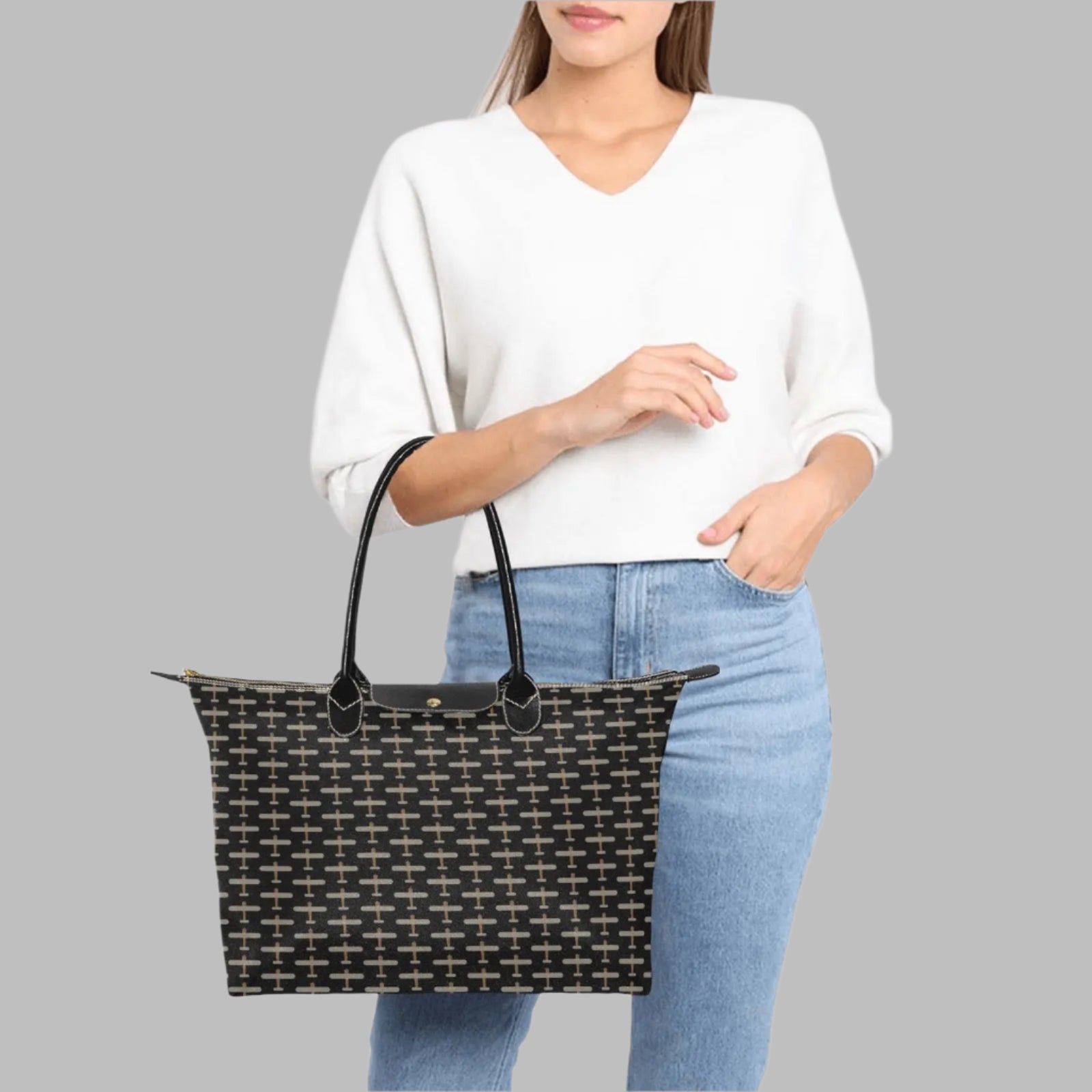 black handbag with beige airplane pattern design