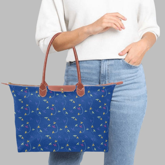 blue handbag with rolled straps and airplane design